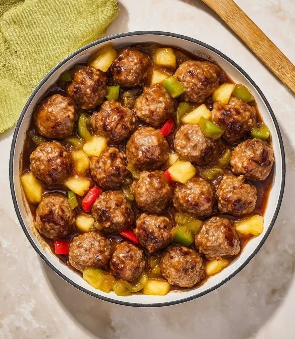 Plate of Waikiki Meatballs garnished with fresh herbs and pineapple.
