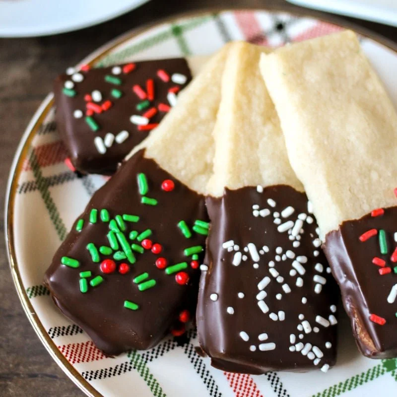 Chocolate Dipped Shortbread Cookies on a plate, drizzled with chocolate